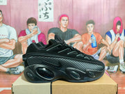 Side profile of a black sneaker with a patterned overlay and sculpted sole
