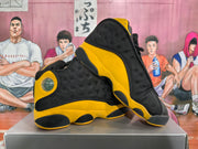 Pair of black and yellow high-top sneakers shown at an angle
