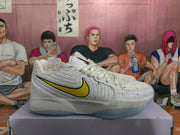 Side profile of a white speckled Nike sneaker with a yellow-and-black Swoosh and translucent outsole.