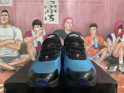 Front view of blue and black Nike Air Max sneakers showing the black laces, toe panels and blue uppers.
