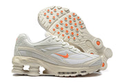 Nike Shox Ride 2 sneakers showing the side profile and outsole with orange traction details.