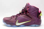 Close side view of a burgundy Nike high-top basketball sneaker with pink laces and neon accents.