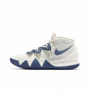 Side view of a Nike Kyrie S2 basketball sneaker in white with navy accents and a navy patterned outsole.