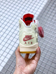 Rear view of the off-white sneaker showing red Nike Air branding and a yellow outsole edge.