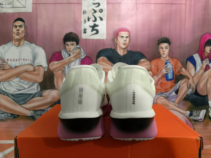 Rear view of white Nike running shoes with pink heel accents