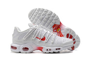 Side and outsole views of white sneakers with red accents and visible cushioning units.