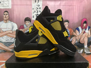 Angled product view showing a pair of black and yellow high-top sneakers with contrasting midsoles.