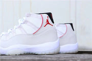 Side view of the white high-top sneaker with red trim and translucent outsole.