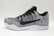 Side view of black-and-white Nike Kobe 11 low-top sneakers