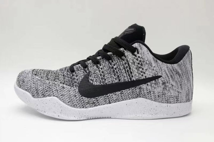 Side view of black-and-white Nike Kobe 11 low-top sneakers