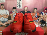 Front view of red Nike high-top basketball shoes with covered fastening and yellow-accented side details.