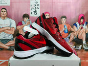 Angled view of the red and black Nike basketball sneakers showing the textured uppers, layered heel design, white midsoles, and black outsoles.