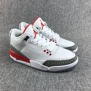 Pair of Air Jordan 3 sneakers in white, red, and grey, viewed from the front side
