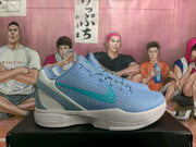 Side view of blue and teal Nike Kobe basketball shoes with textured uppers