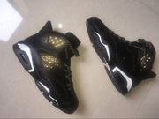 Angled pair of black high-top sneakers showing perforated panels and contrasting white midsole sections.