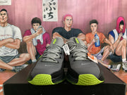 Front view of gray Nike low-top sneakers with black panels and lime-green details
