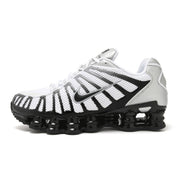 Side profile of a white Nike Shox TL sneaker with silver and black overlays.