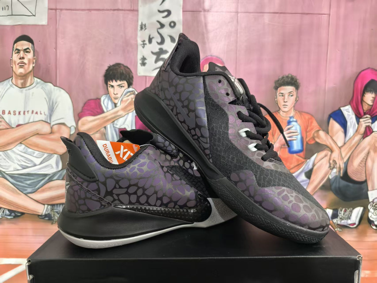 Pair of black and dark purple patterned basketball sneakers displayed on a shoebox.
