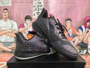 Pair of black and dark purple patterned basketball sneakers displayed on a shoebox.
