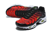 Angled view of red and black Nike Air Max Plus sneakers with black laces and white soles.