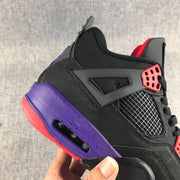 Close-up of the side mesh panel, black upper, purple midsole, and red lace eyelet.