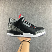 Air Jordan 3 Black Cement sneaker shown from the side above its shoebox; box label visible