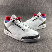 Three-quarter front view of the white high-top sneakers with patterned toe and heel overlays.