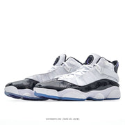 Side view of the pair showing white uppers, glossy black overlays, ankle straps and blue-purple outsoles.