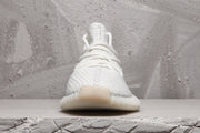 Front view of a white Yeezy 350 V2 sneaker with tonal laces and a rounded toe.