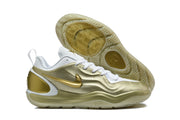 Side and outsole view of a white and gold Nike sneaker with patterned tread.