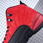 Close-up of the red upper, black eyelets, stitching, and textured side panel with Jordan lettering.