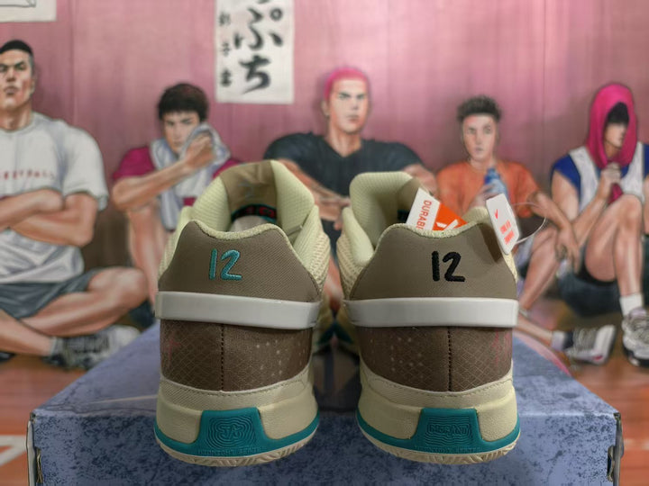 Rear view of coconut-milk and teal Nike basketball sneakers showing brown heel panels, contrasting heel details, and textured outsole sections.