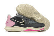 Side view of a charcoal, pink, and cream Nike Kyrie shoe with outsole visible
