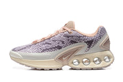 Side view of purple snake-print Nike Air Max DN sneakers with pink laces and a cream sole