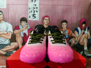 Front view of the neon pink Nike sneakers with black-and-green laces, black tongues, and translucent textured toe boxes.