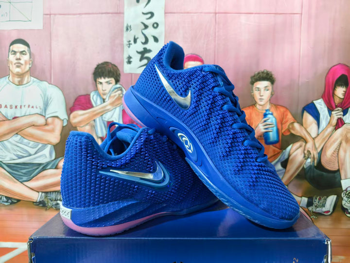Pair of royal blue Nike Kobe basketball shoes with metallic-look Swooshes, shown at an angle.