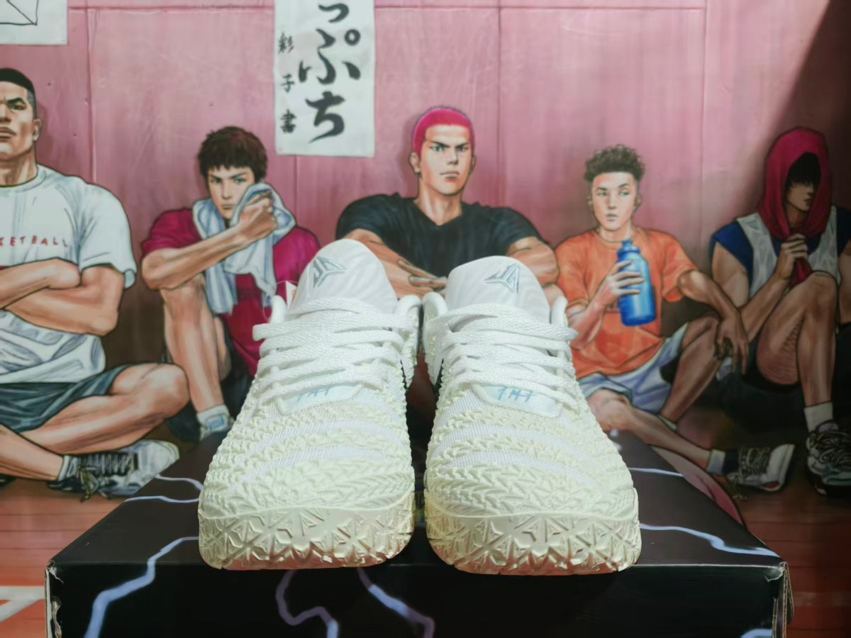 Front view of white Nike basketball sneakers with textured uppers and white laces.