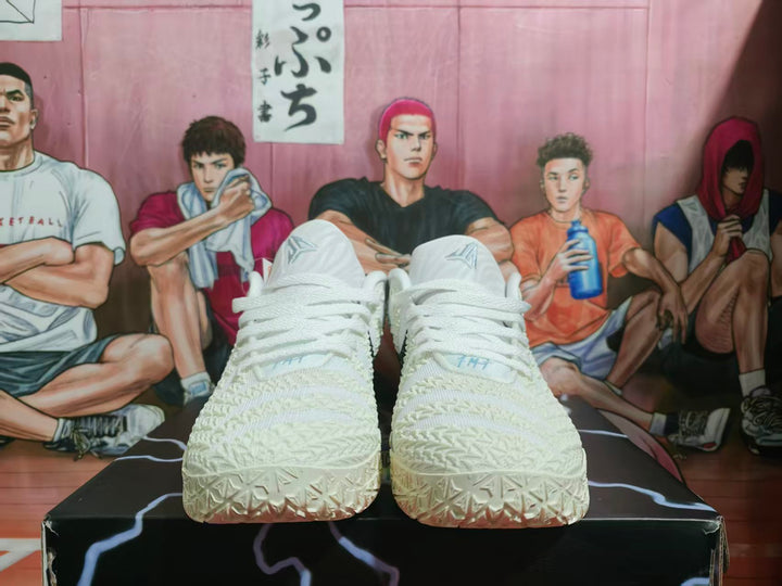 Front view of white Nike basketball sneakers with textured uppers and white laces.