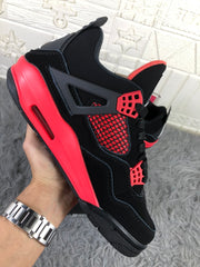 Side view of the sneaker showing the black upper, red midsole section, and side cage.