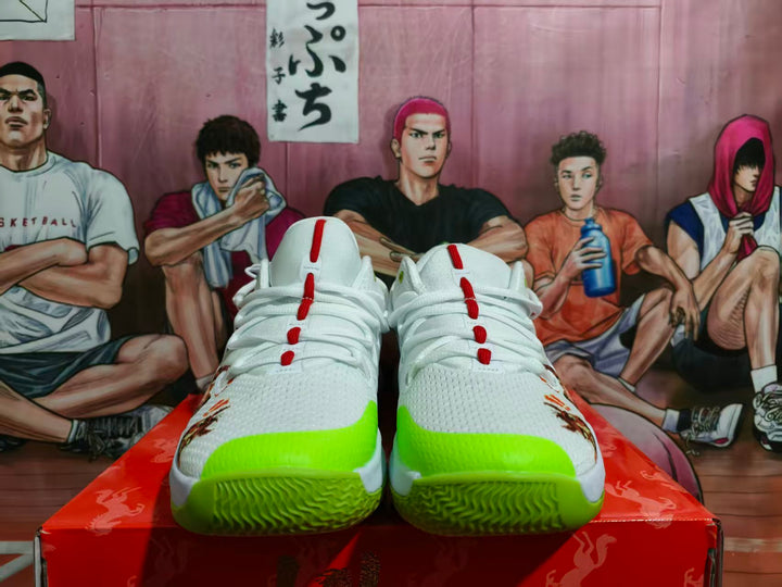Pair of white Nike Zoom basketball shoes with fluorescent green toe accents and red lace details, shown from the front.