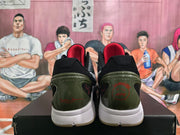 Rear view of black and white basketball shoes with red heel graphics, dark olive-toned heel panels, and white midsoles.