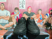 Front view of black Nike basketball sneakers with textured uppers, black laces, and white branding details.