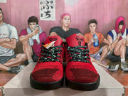 Front view of the red and black basketball sneakers showing patterned laces, red toe boxes, black outsoles, and tongue emblems.
