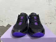Front view showing black laces, purple accents, and black-and-purple toe areas.