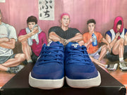 Front view of blue and white Nike basketball sneakers with white textured soles.