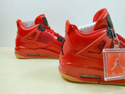 Rear and side view of the red sneakers showing the padded collars, side mesh panels, and gum-colored outsoles.