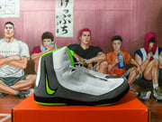 Side profile of a gray and black Nike wrestling shoe with bright green accents.