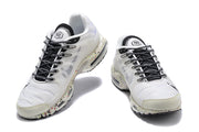 Front view of the pair showing black-and-white laces, white uppers, and speckled soles