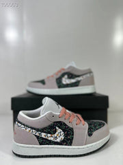 Angled view showing the pink laces, floral-patterned side panels, and contrasting swoosh design.