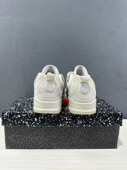 Rear view showing the heel panels, pull tabs, and circular heel details on the sneakers.